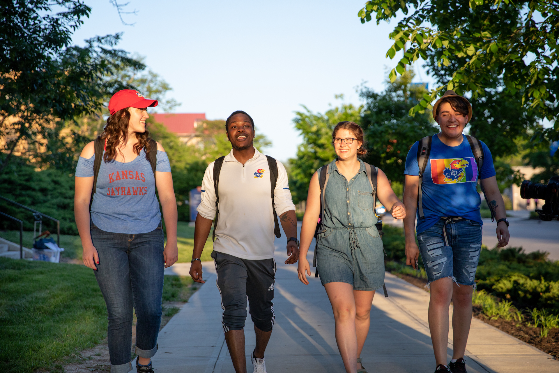 Four students walking down Jayhawk Blvd.