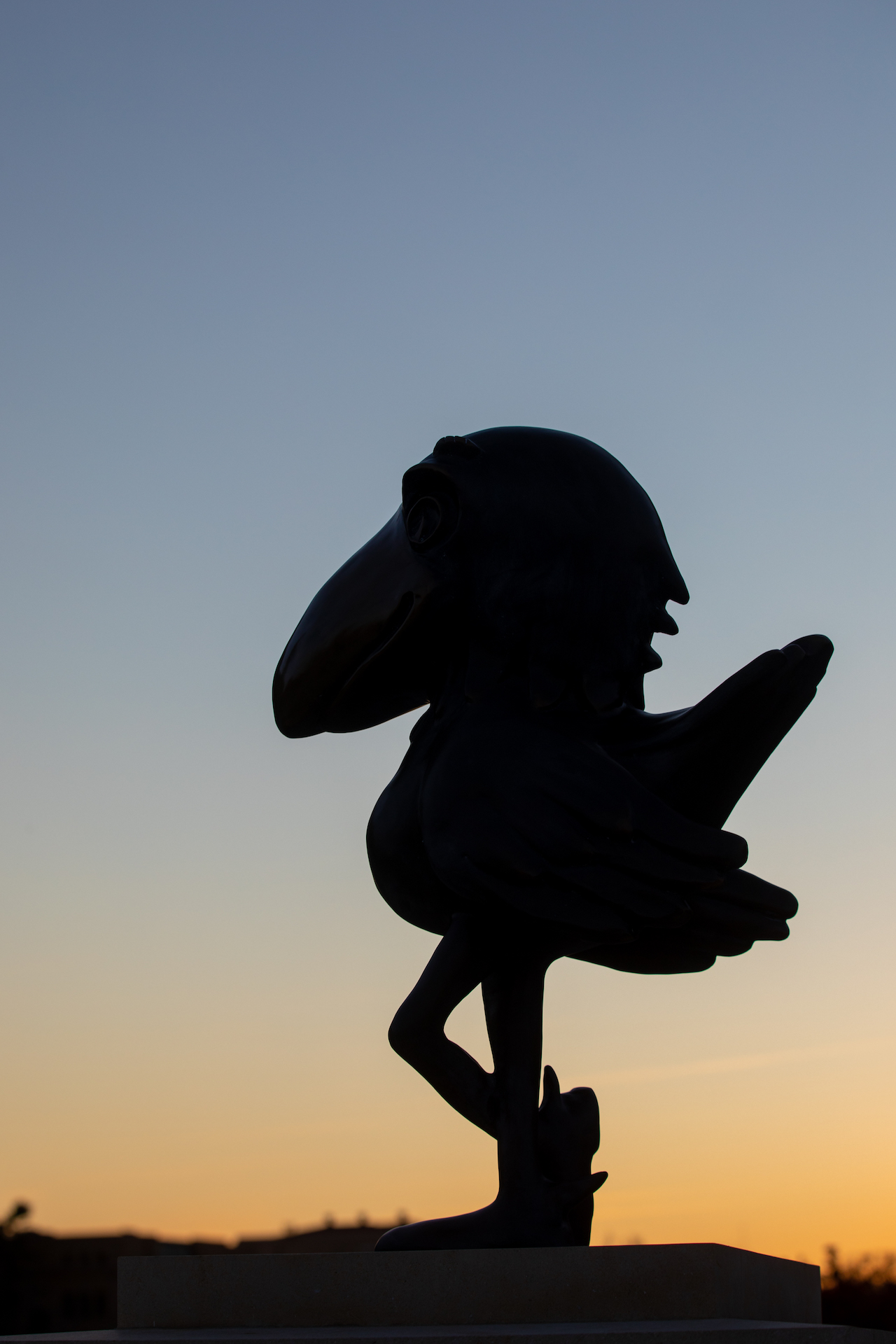 Jayhawk statue silhouette with sunset in background