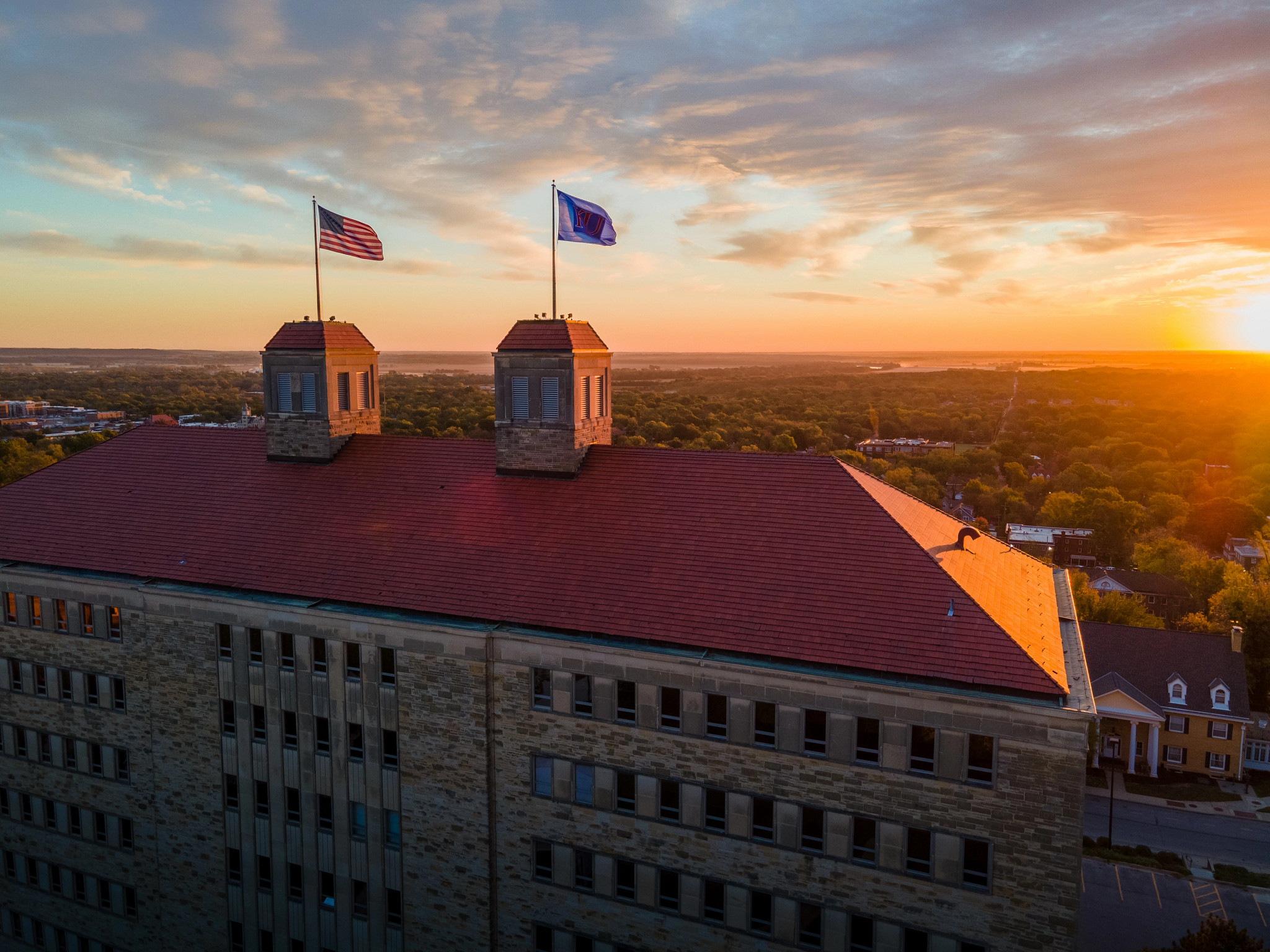 Fraser Hall at Sunset showing the sun and Clinton Lake in distance