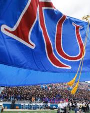 KU flag waving in front of stadium