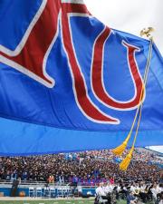 KU flag waving in front of stadium